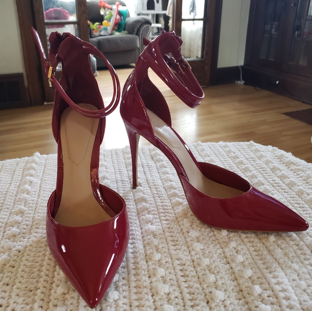 Red patent leather Aldo stilettos US size 8 w/ 2 strap detail and gold buckles.